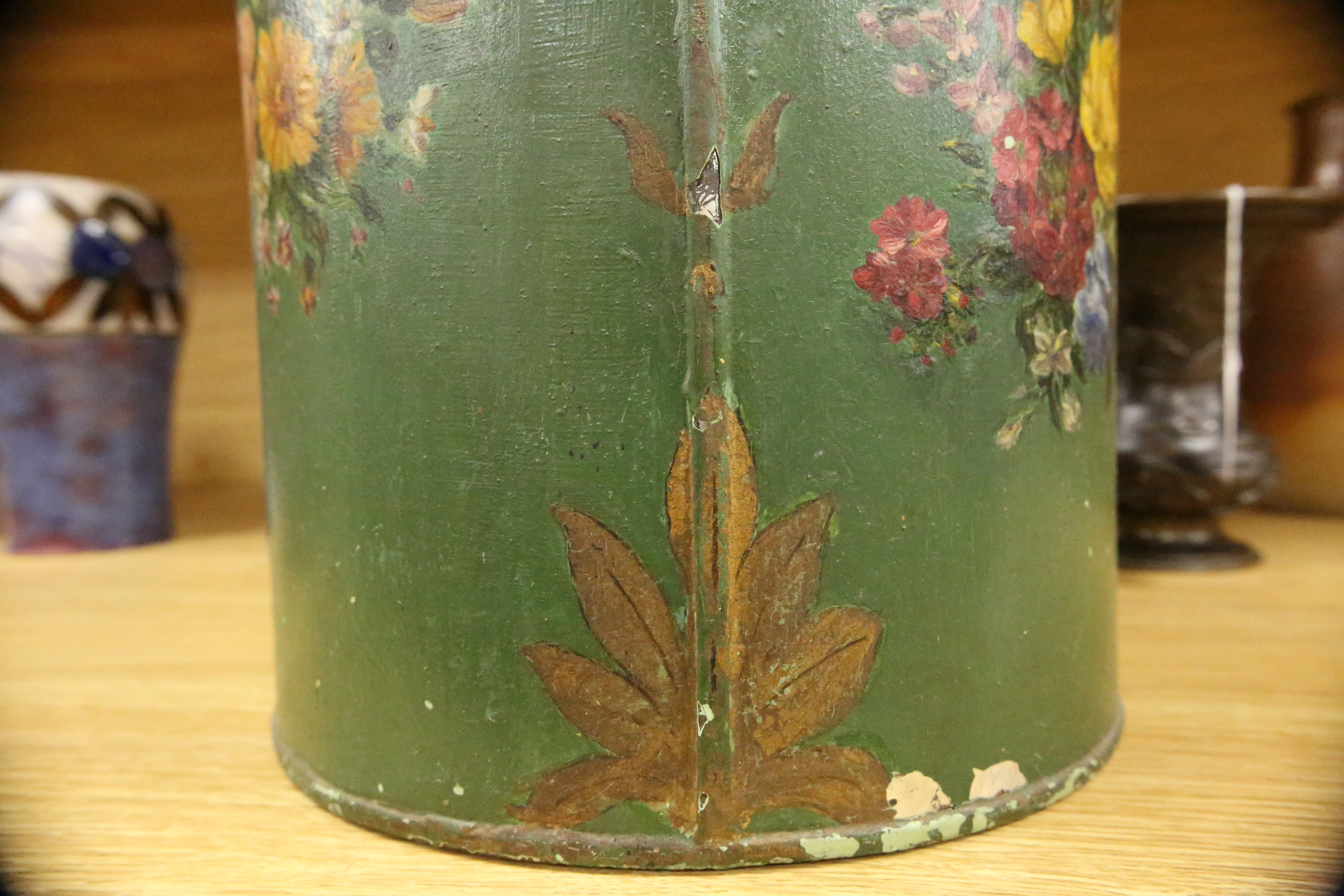 A green toleware floral decorated tea canister, 42cm high. Condition - poor, many chips to surface paint